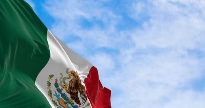 High-resolution 3D render of the national flag of Mexico waving in the sky. The emblem features the Aztec eagle, serpent, and cactus, symbol of freedom, heritage, and national identity