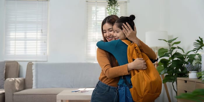 A touching hug between a woman and a girl signifies the love and support shared as they prepare for the new school year, enhancing family bonds.