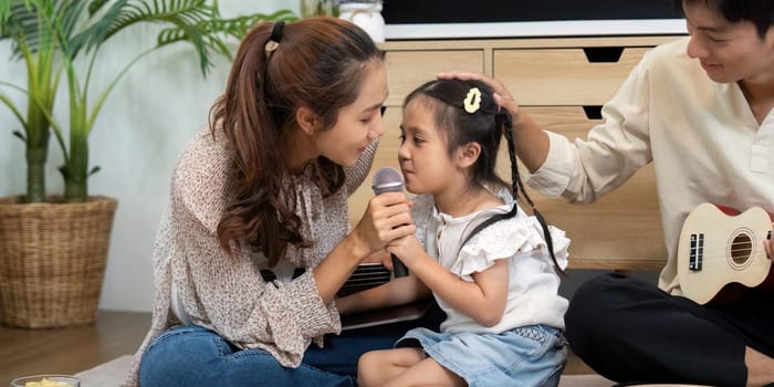 A mother and daughter engage in a heartfelt singing session, showcasing their strong emotional bond and love for music in a relaxed environment.