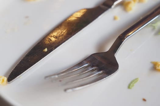 Cutlery rests on a nearly empty plate, indicating a finished meal.