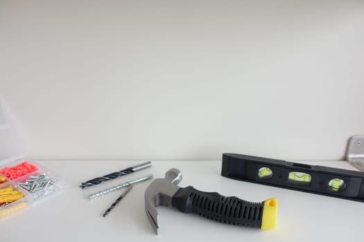 Various tools and hardware organized on a clean workspace for repairs.