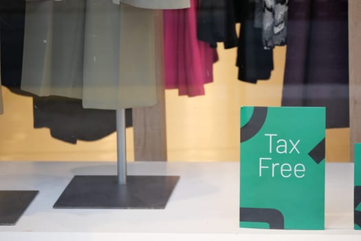 Retail window highlights tax free promotion alongside stylish clothing.