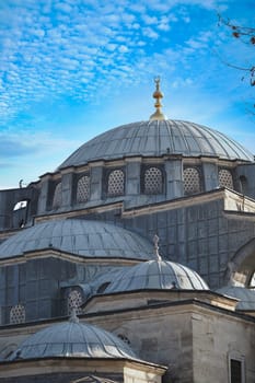 Beautiful domes of a historic mosque stand out against a vibrant sky.