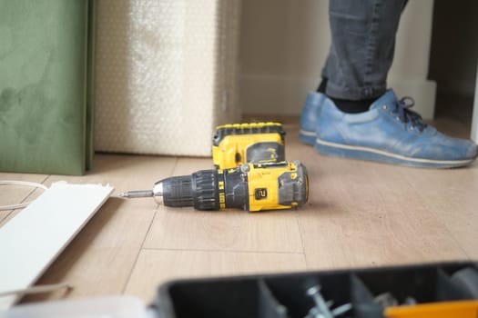 Tools are placed on the floor during a home renovation activity.