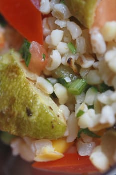 Fresh salad features bulgur wheat mixed with diced vegetables and herbs.