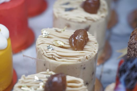 Delicious desserts with creamy frosting and toppings are beautifully arranged.