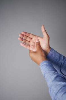 young man suffering wrist pain .