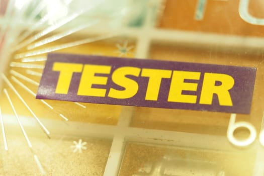 Bold text shows a tester label at a cosmetics display counter.