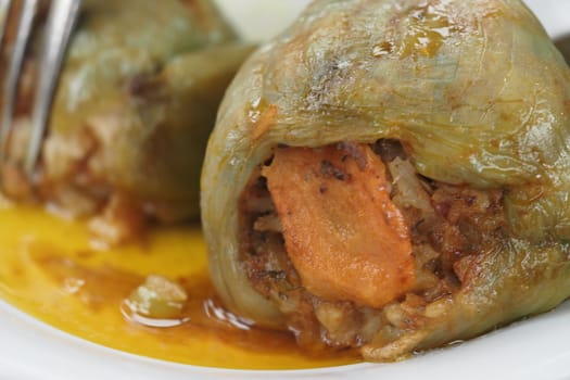 Savory stuffed peppers filled with rice and meat on a plate.