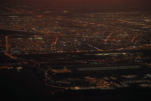 Aerial view of a vibrant urban landscape sparkling at night.