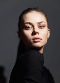 A captivating portrait of a young woman exuding confidence, with a focused gaze and minimalistic styling, perfect for beauty and fashion concepts.
