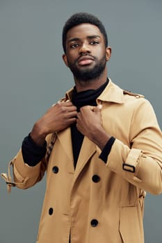 This image features a stylish young man in a beige trench coat, radiating confidence and sophistication, ideal for fashion, lifestyle, and seasonal marketing campaigns