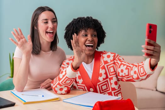 African American and Caucasian students take a cheerful selfie while studying together. They smile, pose, and enjoy a fun break indoors with notebooks, showing friendship and youthful energy.