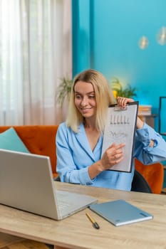 Caucasian businesswoman freelancer making online presentation video laptop call education lessons for remote study student classes at office workplace. Female demonstrates graphic analytics at home.