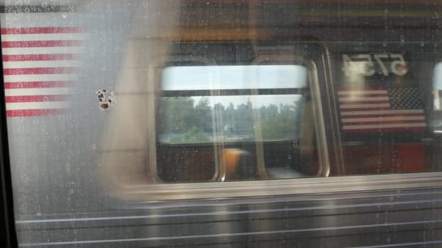 New York City, United States - 2 Sept 2023: Subway train. Shaking camera thru dirty window. Queens metro transport, metropolitan traffic. Passenger elevated railway. Urban life of residential district