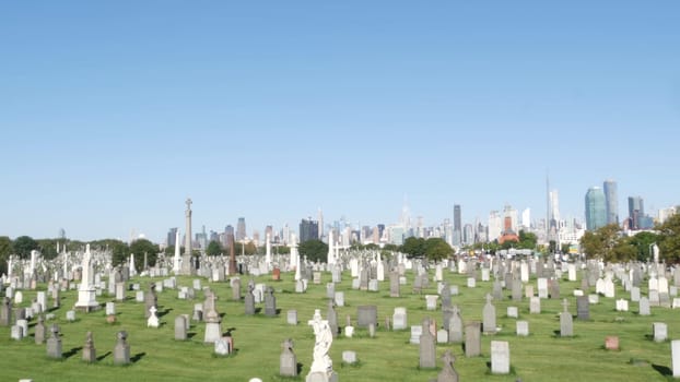 New York City, United States - 14 Sept 2023: Calvary cemetery in Queens, USA. Manhattan Midtown urban skyline cityscape architecture. Tombstones on graves, huge graveyard. Large cemetry grass lawn.