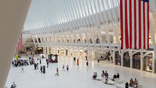 New York City, United States - 10 Sept 2023: World Trade Center Oculus transport hub architecture. Manhattan Downtown Financial District, USA urban life. People. September 11 remembrance american flag