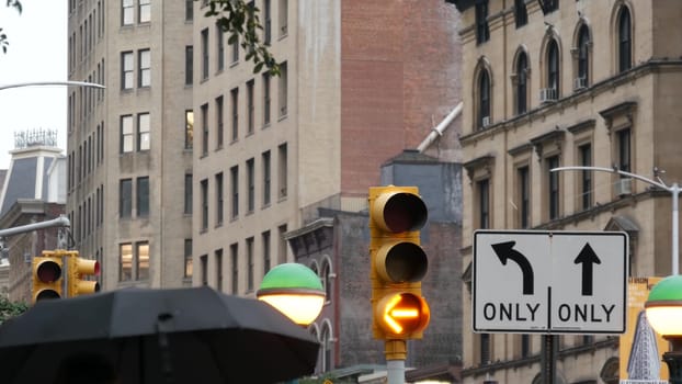 New York City, United States - 8 Sep 2023: Subway entrance globe, orb lamp. Yellow traffic light, Manhattan Midtown road intersection, street crossroad sign. Metropolitan underground metro transport.