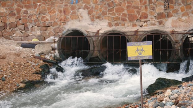 Close up of warning sign lable biohazard caution of collects sample of waste water from industrial, Conserve water and Environment Issue concept