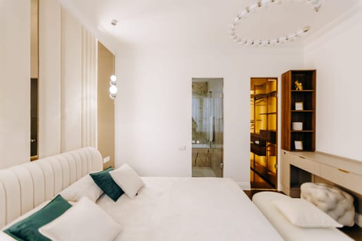 This is a spacious bedroom that features a large bed, complemented by a walkin closet that offers ample storage space for clothing and accessories