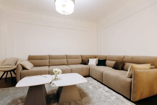 In a beautifully decorated living room, there is a large and comfortable sectional couch accompanied by a stylish coffee table