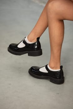 Shiny Black Patent Leather Loafers Side View Classic and Elegant Footwear for Women.
