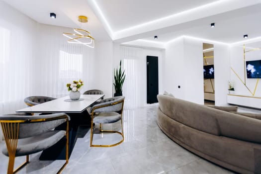 A cozy and inviting living room that features a dining table paired with chairs alongside a comfortable couch for relaxation