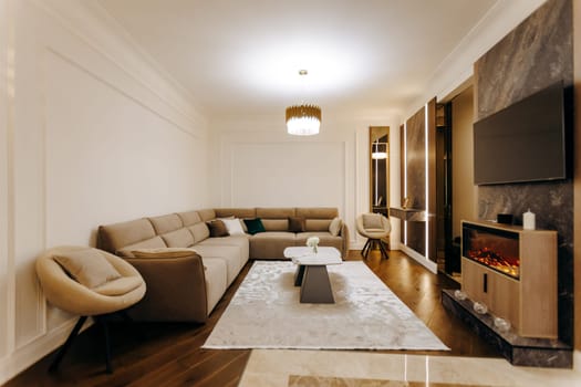 The living room features a cozy couch, a comfortable chair, a modern television, and a welcoming fireplace, making it a perfect gathering space