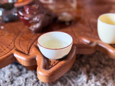 Ceramic tea cup placed with care during traditional tea gathering. Quiet beauty of a tea ceremony and its meditative atmosphere