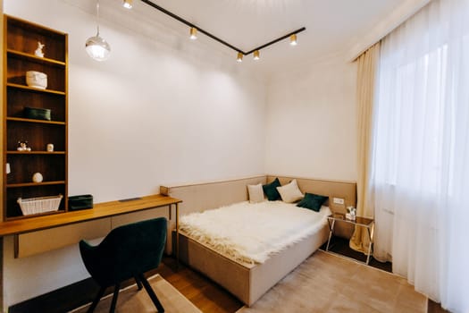 The bedroom features a comfortable bed, a stylish desk, a cozy chair, and sturdy shelves for storage and decor