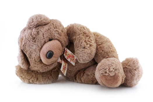 A big brown teddy bear relaxing