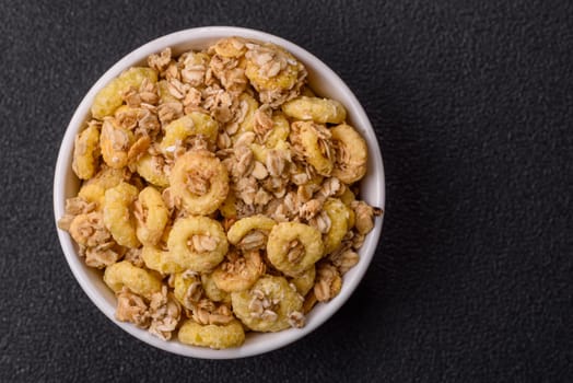 Flakes, chocolate balls and dried fruit for a hearty breakfast. Granola with chocolate flakes