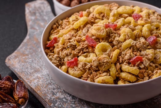 Flakes, chocolate balls and dried fruit for a hearty breakfast. Granola with chocolate flakes