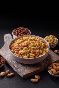 Flakes, chocolate balls and dried fruit for a hearty breakfast. Granola with chocolate flakes