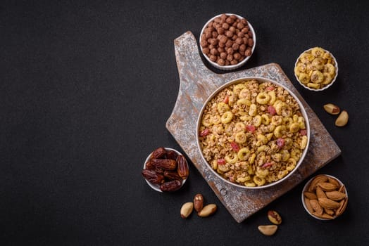 Flakes, chocolate balls and dried fruit for a hearty breakfast. Granola with chocolate flakes