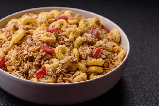 Flakes, chocolate balls and dried fruit for a hearty breakfast. Granola with chocolate flakes