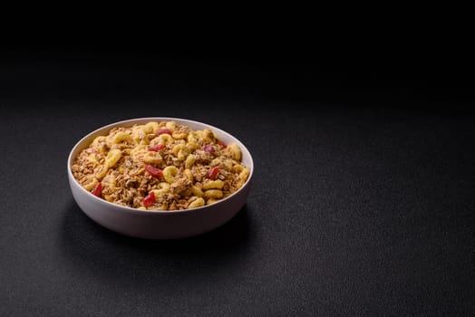 Flakes, chocolate balls and dried fruit for a hearty breakfast. Granola with chocolate flakes