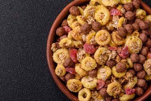 Flakes, chocolate balls and dried fruit for a hearty breakfast. Granola with chocolate flakes