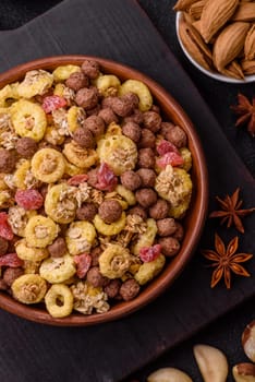 Flakes, chocolate balls and dried fruit for a hearty breakfast. Granola with chocolate flakes
