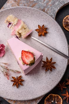 A slice of pink colored puff cake for a birthday celebration. Sweets to celebrate a wedding or valentine's day