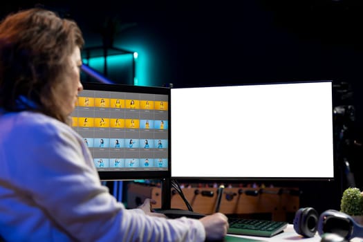 Photo editor using isolated screen monitor to color correct photographs in creative studio. Photographer selecting best pictures for editorial content with mockup desktop computer