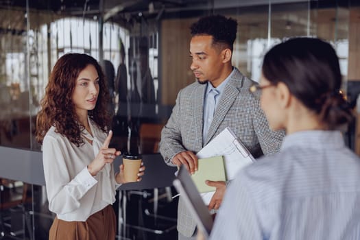 In a sleek office, professionals engage in discussions that encourage teamwork and effective communication