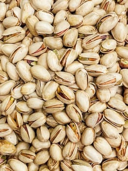 lots of ripe pistachio nuts for cooking as background