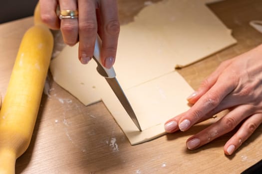 A woman cuts puff pastry