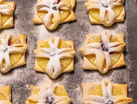 Just baked fruit puff pastry on the baking tray, dusted with powdered sugar