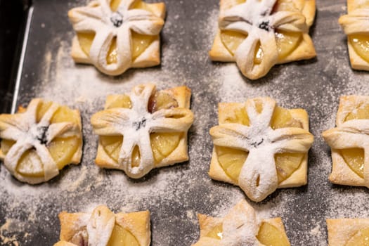 Just baked fruit puff pastry on the baking tray, dusted with powdered sugar
