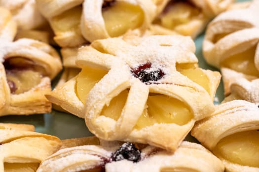 Freshly baked fruit puff pastries on the ceramic plate
