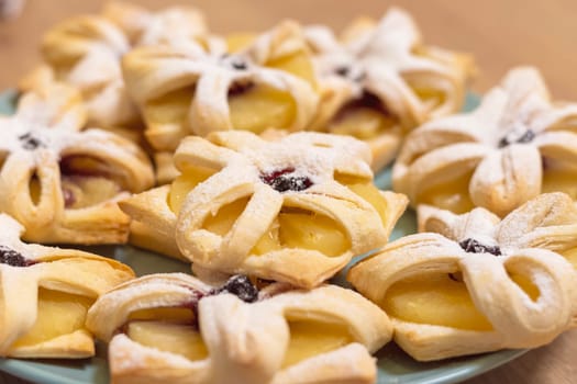 Freshly baked fruit puff pastries on the ceramic plate