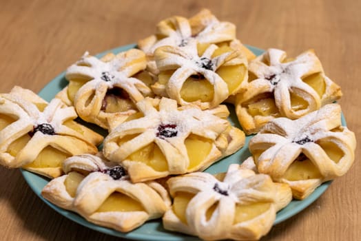 Freshly baked fruit puff pastries on the ceramic plate