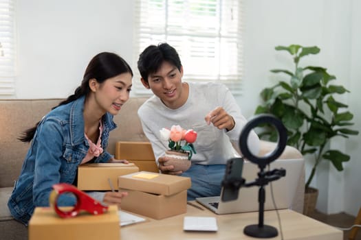 An engaged couple preparing their workspace for a live streaming session, ready to connect with their online audience and showcase innovative products.